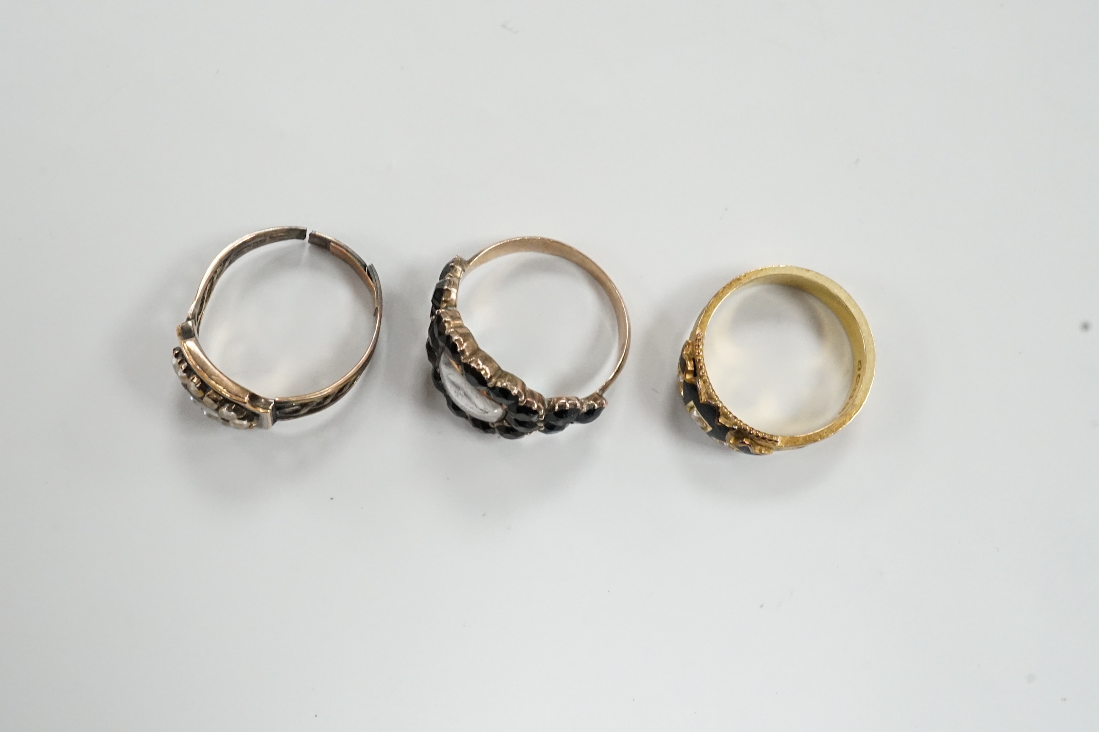 Three assorted Georgian mourning rings, including a 15ct gold, seed pearl and black enamel.